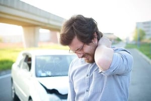 man in pain and suffering from a whiplash injury in need of chiropractic care.