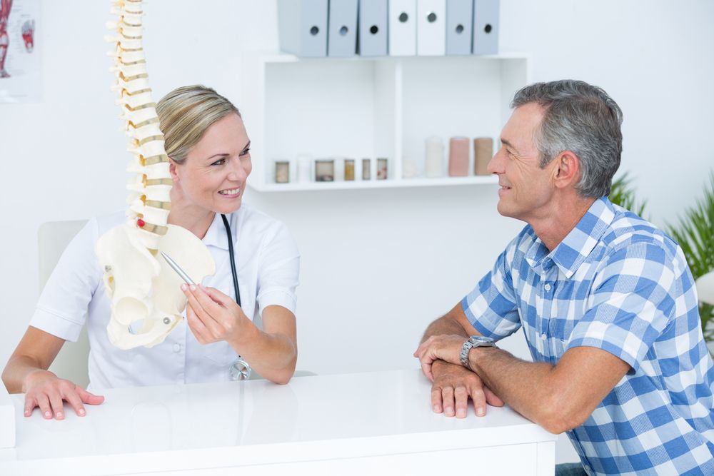 Chiropractor speaking with a patient